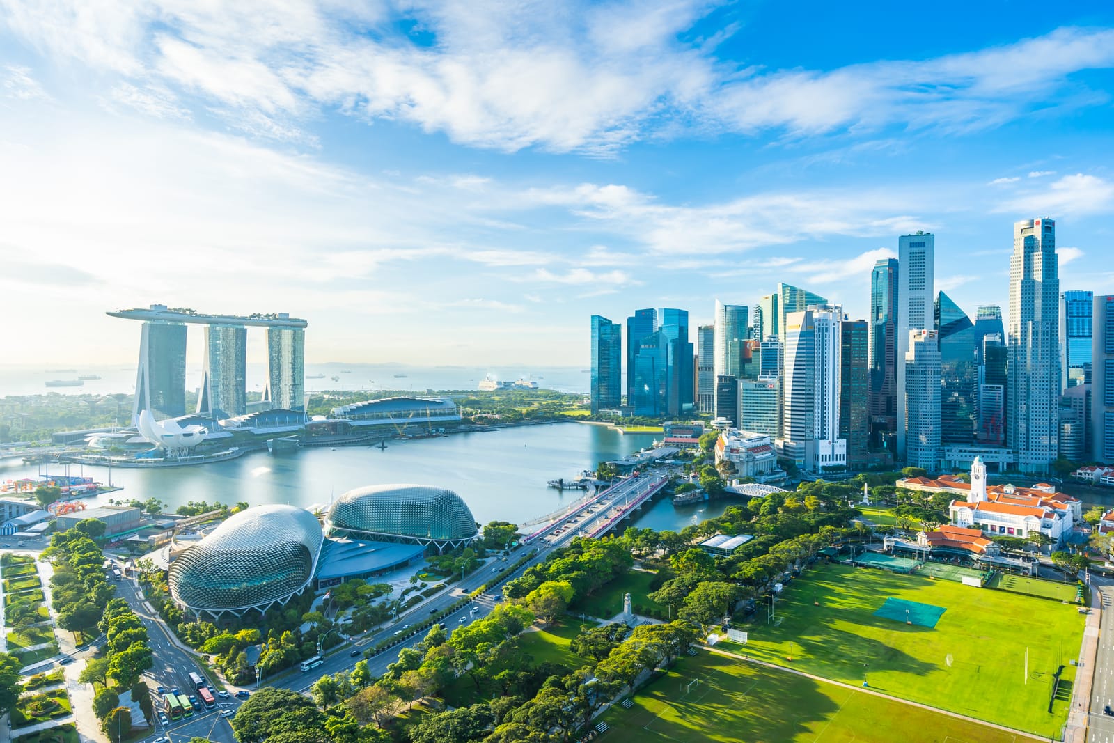 Marina Bay Sands, the Esplanade domes and the CBD towers seen above the Padang on a sunny morning